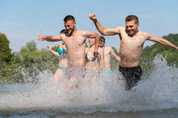 istock group of happy friends having fun on river 1308547481