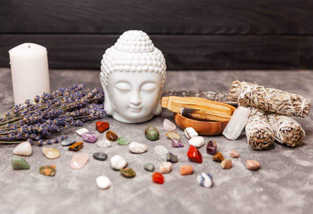istock Selection of semiprecious stones. Ceramic statuette of a Buddha head. 1308549010