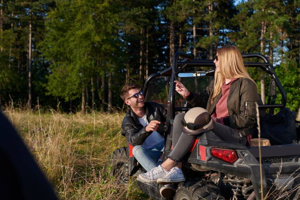 istock couple enjoying beautiful sunny day while driving a off road buggy 1308549180