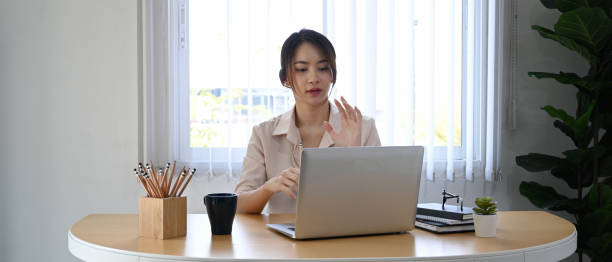 istock Young businesswoman using laptop computer virtual video conference with her business partner. 1308552324