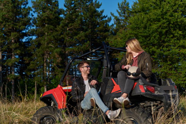 istock couple enjoying beautiful sunny day while driving a off road buggy 1308552344