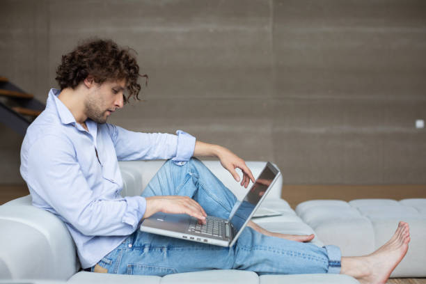 istock Young man freelancer working at home on laptop. 1308553480
