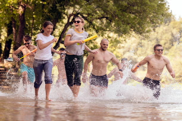 istock group of happy friends having fun on river 1308554332