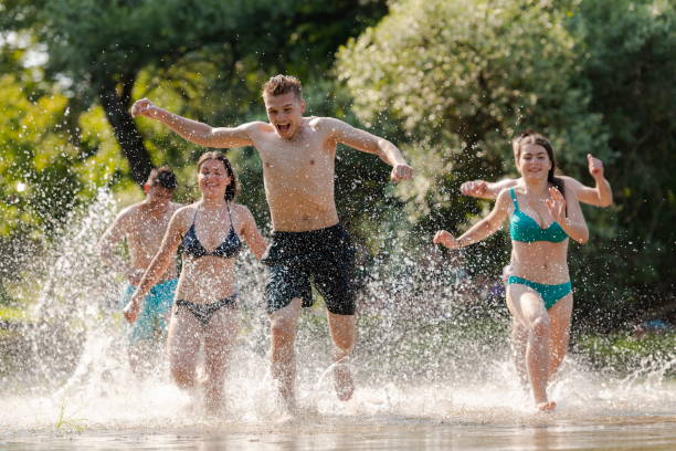 istock group of happy friends having fun on river 1308554420