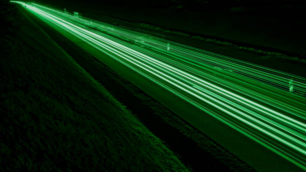 istock green car lights at night. long exposure 1308555639