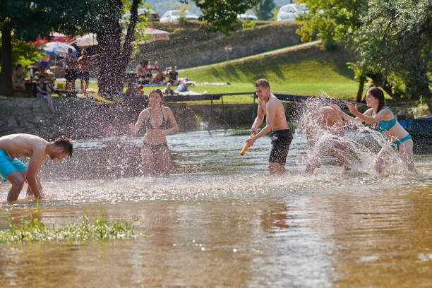 istock group of happy friends having fun on river 1308556254
