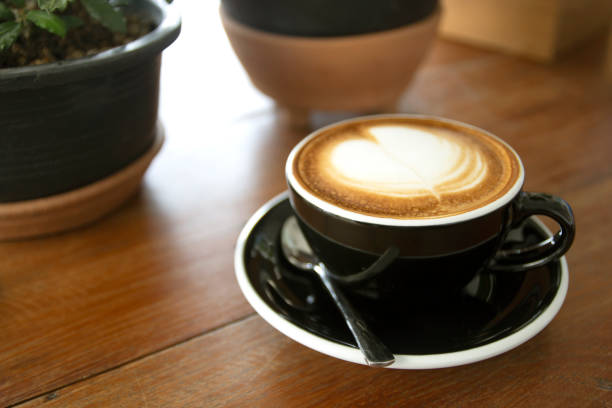 istock Coffee in cup on wooden table in cafe 1308557702