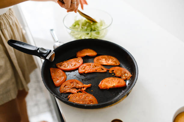 istock fried tomatoes in a frying pan. cherry 1308557704