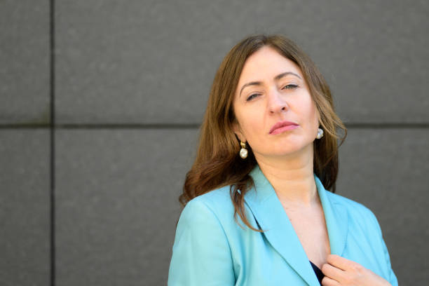 istock Thoughtful middle-aged woman squinting at the camera in contemplation 1308558708