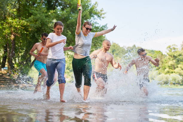 istock group of happy friends having fun on river 1308559644