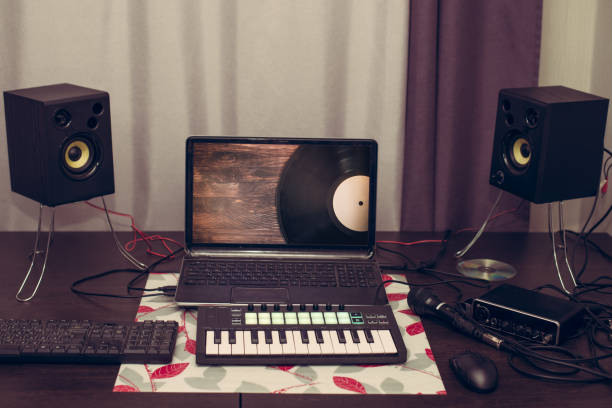 istock Musician's workplace, MIDI keyboard, computer speakers. Musician's table 1308560058