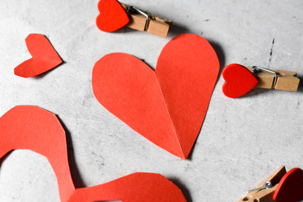 istock Red paper hearts and heart clips on a gray backround 1308561672