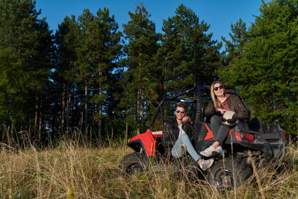 istock couple enjoying beautiful sunny day while driving a off road buggy 1308562538
