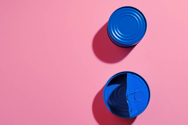 istock Aesthetic concept with blue painted tin can on pink background 1308562813