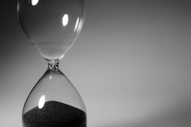 istock Black and white photo of hourglass close up 1308564509