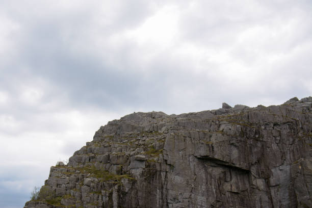 istock Jagged rocks and clouds rolling-in in the background 1308564588