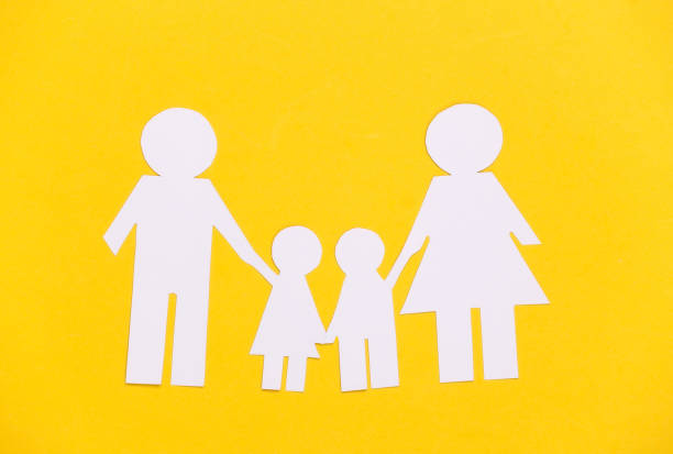 istock Paper happy family together on yellow background. 1308564672
