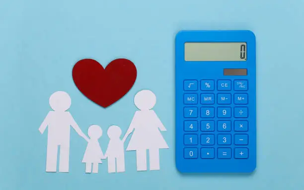 Photo of Paper happy family together with calculator on blue background. Calculation of family expenses, budget