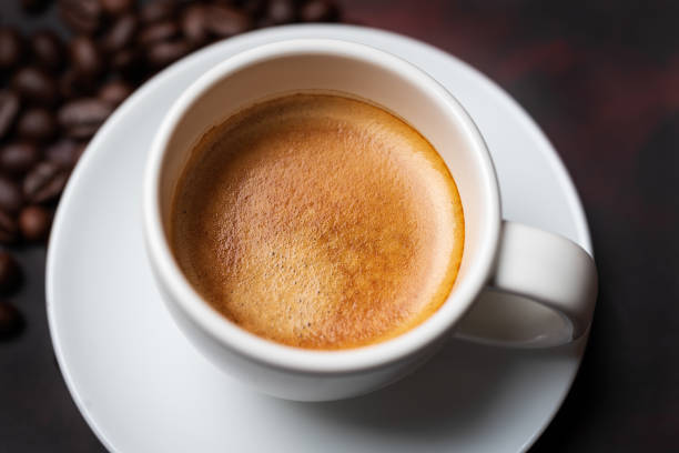istock Coffee espresso and roasted beans on dark background close up 1308564840