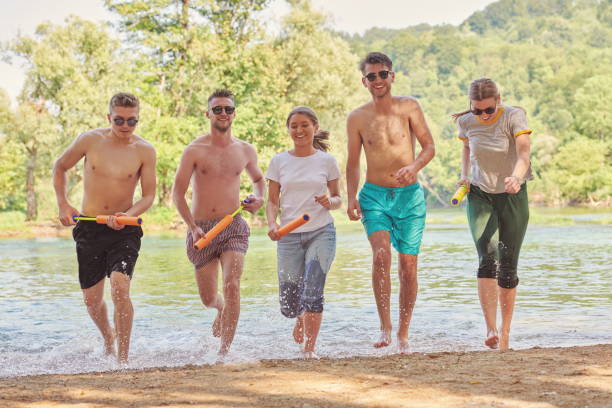 istock group of happy friends having fun on river 1308565625
