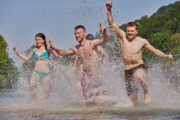 istock group of happy friends having fun on river 1308567007