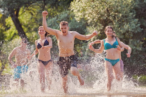 istock group of happy friends having fun on river 1308567138