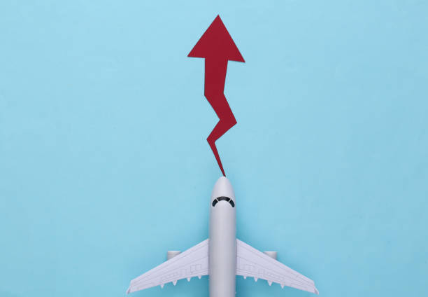 istock Airplane with growth arrow on a blue background. Top view 1308567493