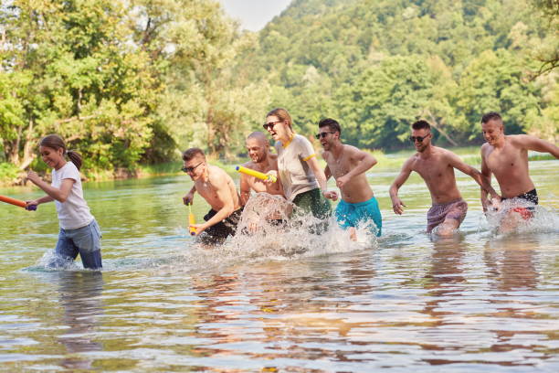 istock group of happy friends having fun on river 1308568089