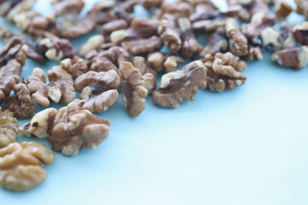Walnuts on blue background. Benefits of nuts in daily human diet concept