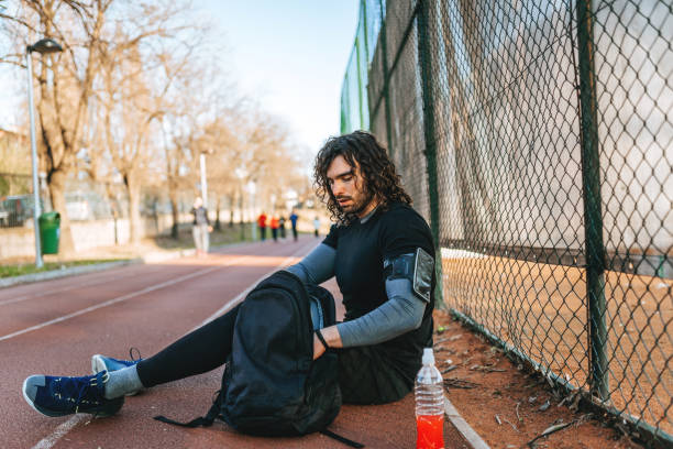 istock Leaning on fence - man sport 1308568772
