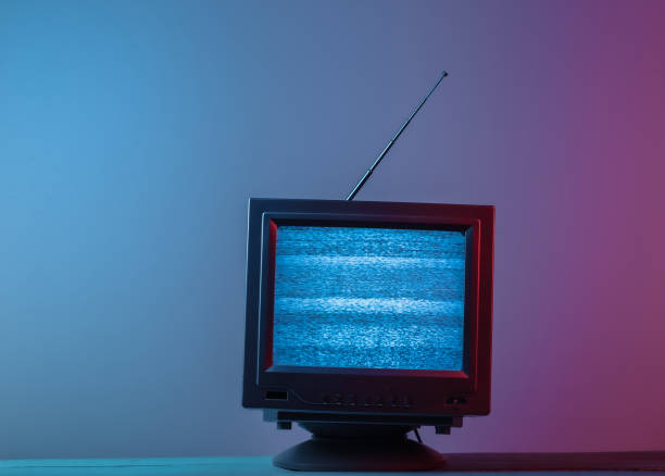 istock Mini Retro tv antenna receiver. Old fashioned TV set. Pink blue gradient neon light. Television noise, no signal. 80s retro wave 1308569724