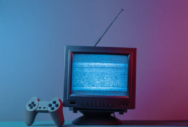 istock Antenna old-fashioned  tv receiver with gamepad in pink blue gradient neon light. Retro media, entertainment 80s, retro wave 1308569732