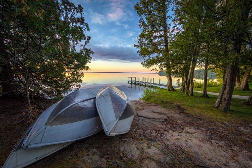 Beautiful sunset with a group of rowboats at Indian Lake State Park in Manistique, Michigan, USA.