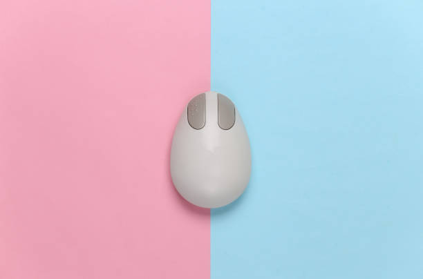 istock Old-fashioned retro pc mouse on pink blue background. Top view 1308569773