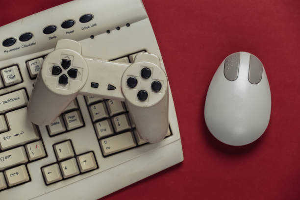 istock Retro entertainment, gaming. Old-fashioned pc keyboard, mouse and gamepad on red background. Top view. Flat lay 1308570002