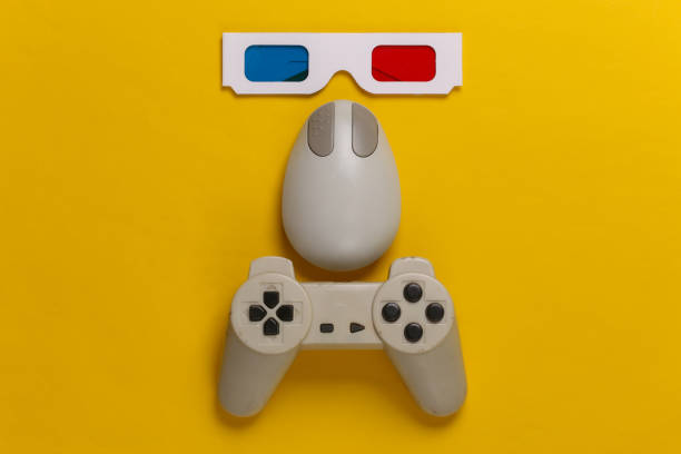 istock Retro entertainment. Attributes, gadgets 80s. Old-fashioned pc mouse, gamepad, anaglyph stereo glasses on yellow background. Top view. Flat lay 1308570076