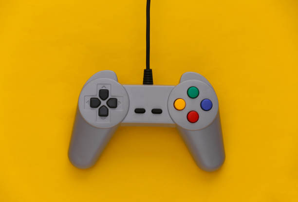 istock Video game Gamepad. Gaming concept. Top view retro joystick on yellow background. 1308570728