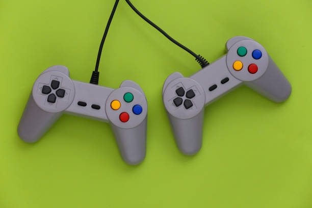 istock Video game Gamepads. Gaming concept. Top view two retro joysticks on green background. 1308570756