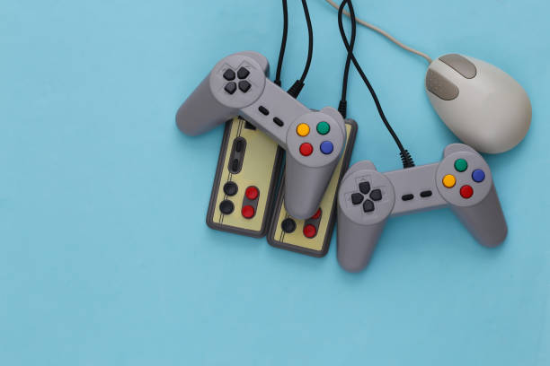 istock Retro joysticks and pc mouse on blue background. Retro gaming, gaming devices, gadgets 1308570767