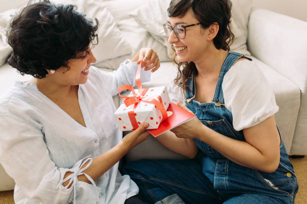 istock Smiling couple opening a gift together 1308572386