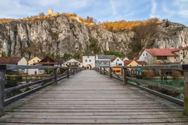 View of Essing market in Altmühl valley with the bridge over the river and the castle on the rock, Germany