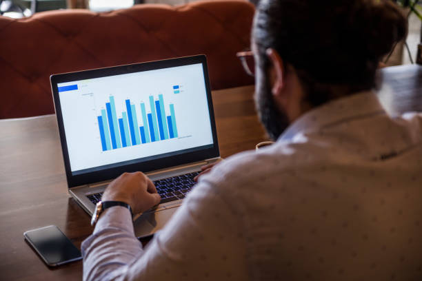 istock Young Businessman looking Financial Charts on laptop 1308575521