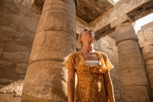 istock Low angle view of woman adventuring inside ancient temple 1308576266