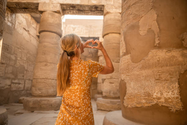 istock Woman makes a heart with hands on temple in Egypt 1308576361