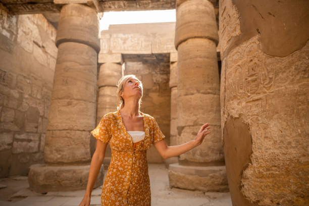 istock Young female traveller wandering through ancient Karnak Temple 1308576402