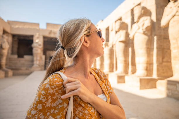 istock Woman explores ancient temple in Luxor, morning light 1308576403