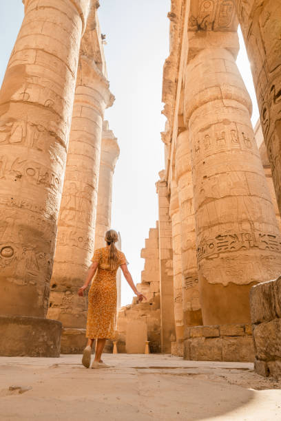 Woman explores ancient temples in Egypt Luxor, Egypt, North Africa luxor thebes stock pictures, royalty-free photos & images