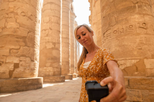 istock Travel blogger uses action camera inside temple in Luxor 1308576430