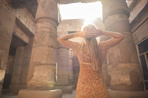 istock Woman contemplates ancient temple in Egypt 1308576434