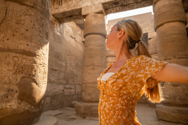 istock Peaceful woman relaxes inside temple at sunrise 1308576457